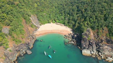 aerial view of secret butterfly beach with rocky bay and fishing boats goa india