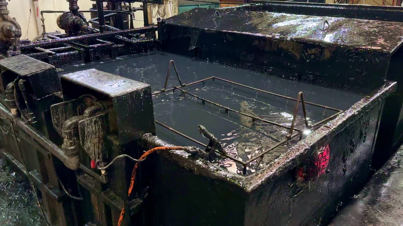 A tub containing black paint liquid for the electroplating process. Iron is inserted into the black paint liquid and is passed through with electricity. The painting process with electroplating.