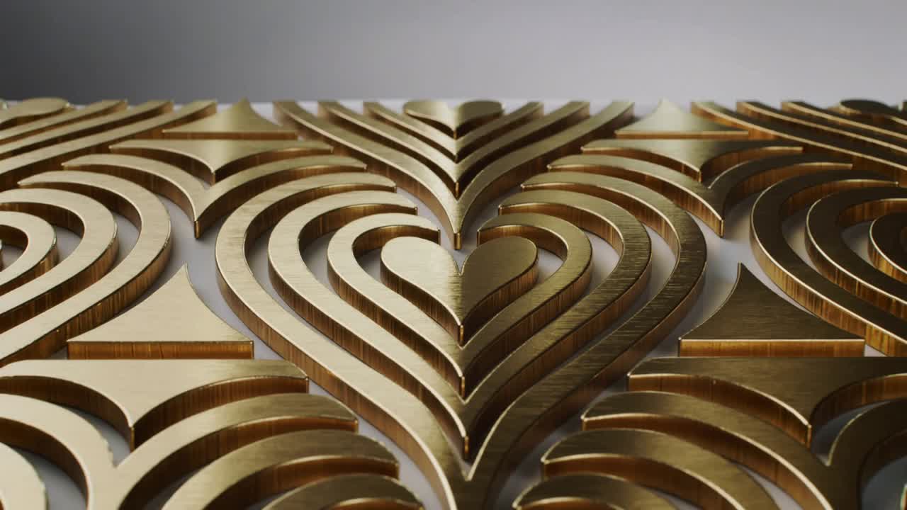 Starting camera moving closer in studio to stacked nested gold hearts revealing white backing