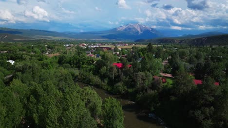 Carbondale-Roaring-Fork-River-Mount-Sopris-Spores-Marble-Basalt-Aspen-Snowmass-summer-aerial-drone-Colorado-June-July-Rocky-Mountain-snow-cap-peaks-Marble-El-Jebel-clouds-sunny-circle-right-motion