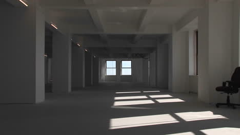An empty building from inside the camera zooms towards the window