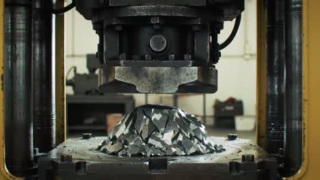 a powerful machine compresses metal pieces, creating innovative shapes in a bustling industrial workshop during the morning. sparks fly as the metal is pressed with precision.