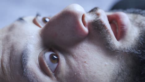 close-up eyes of man waking up in fear and panic.