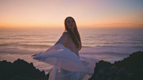 sensual girl waving cloth performing contemporary dance in summer sunset hill