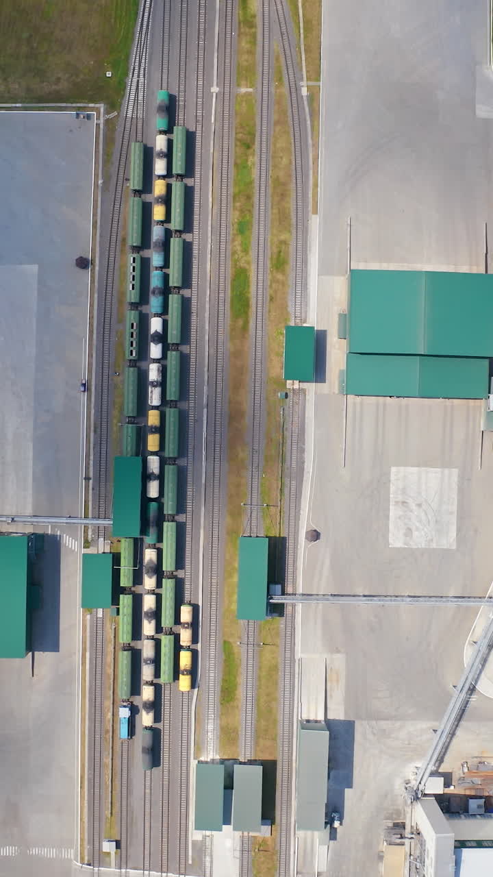 Modern agricultural architecture landscape. Big steel grain elevator warehouse. Vertical video