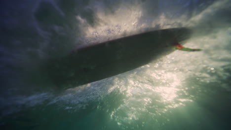 Longboarder-catches-rolling-wave-dropping-in-effortlessly,-underwater-view