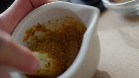 making paste from sesame seeds with mortar and pestle