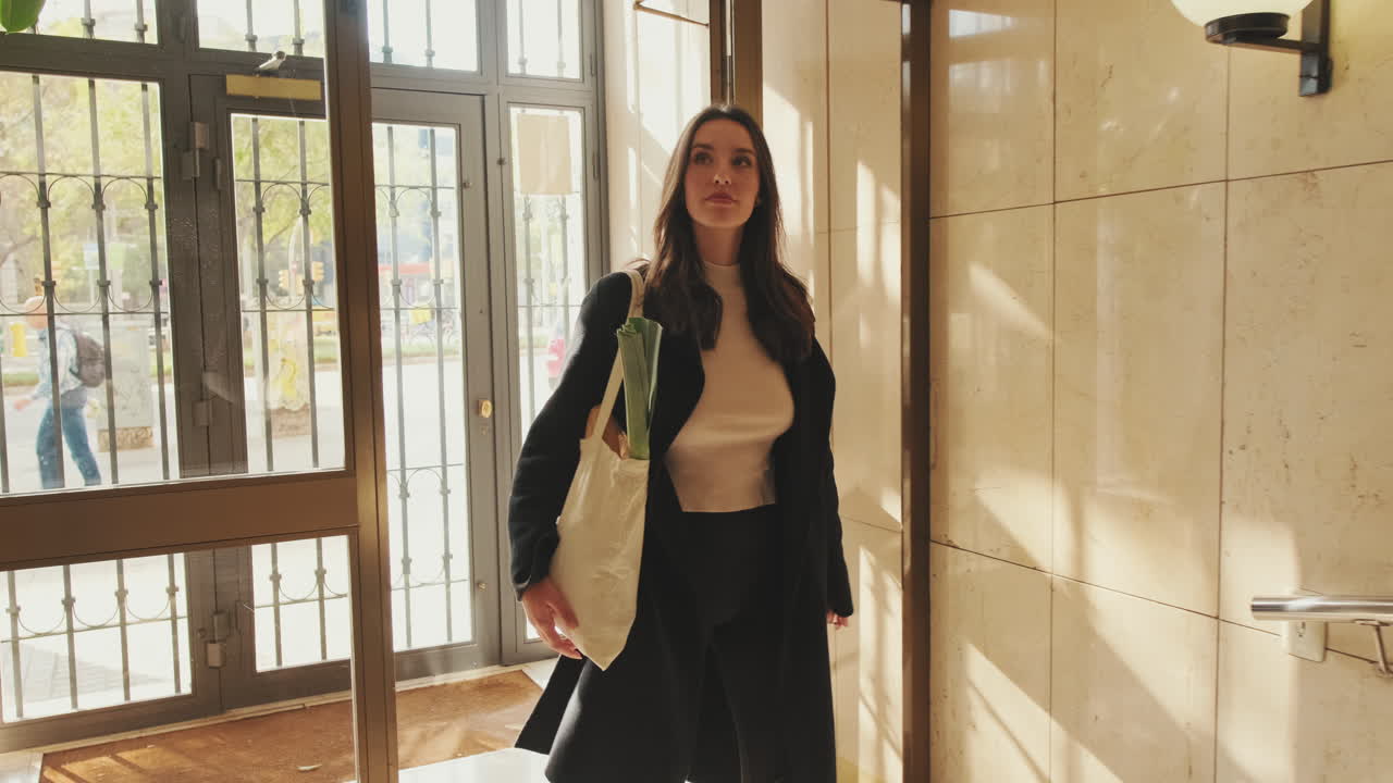 A woman with a shopping bag in an interior setting
