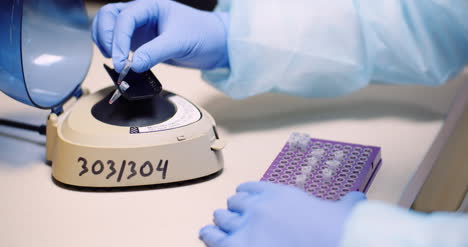 Close-Up-Of-Scientist-Loading-Small-Tubes-In-Laboratory-Centrifuge