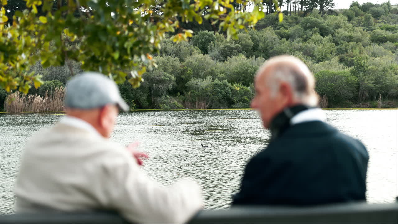 Two elderly men enjoying the view by the lake