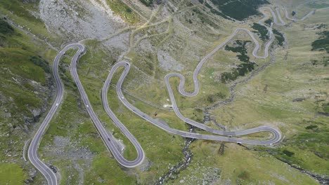 Cars-Drive-Transfagarasan-Mountain-Road-in-Carpathians,-Romania,-Europe---Aerial-4k