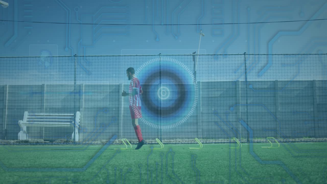Microprocessor connections and round scanner against male soccer player practicing on grass turf