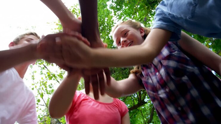 Schoolkids forming hand stack in school premises 4k