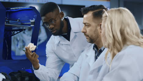 scientists discussing 3d printed model in a laboratory