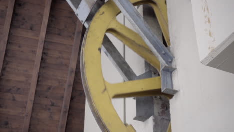 wheel of a gondola in the mountains in the swiss alps, start station, gears