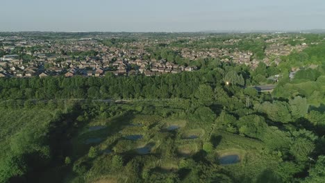 Aerial-shot-flying-across-newt-ponds-at-Mouldon-Hill-Country-Park-in-England