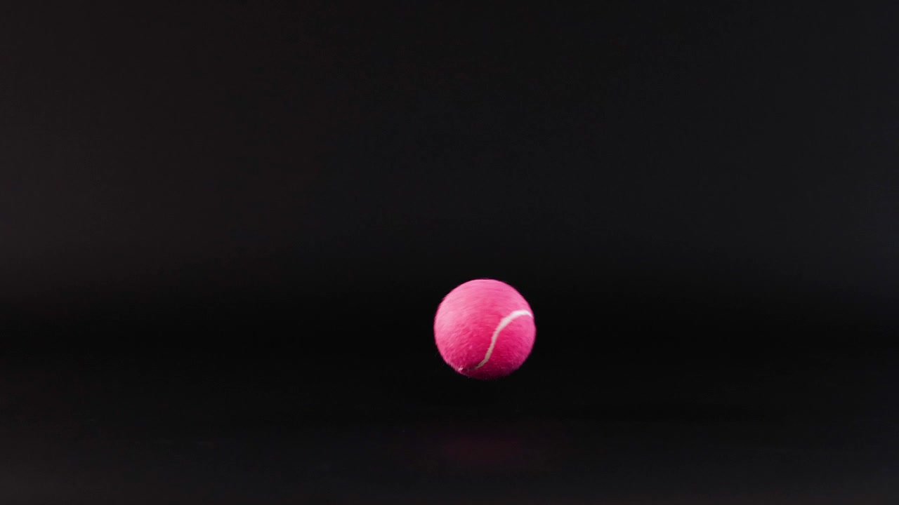 Pink ball bouncing on a dark background