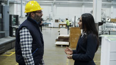 smiling project manager shaking hands with technician