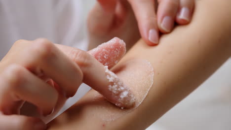 applying salt scrub to arm
