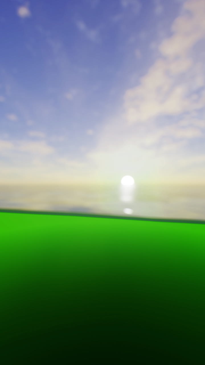 Sunrise over calm waters with vibrant green foreground at serene location