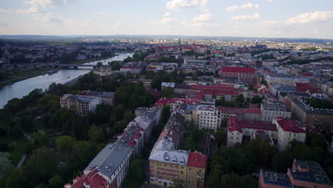 Aerial-panoramic-shot-of-Vistula-River-and-Cityscape-of-Krakow-during-dusk-in-Poland