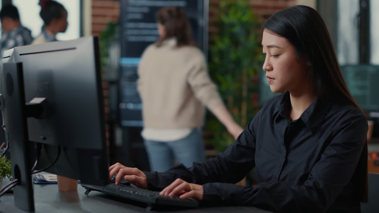 Programer writing algorithm focused on compiling source code sitting at desk