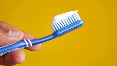 Hand-holding-tooth-brush-with-copy-space