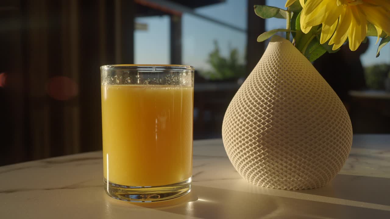 Orange juice and sunflower on a table