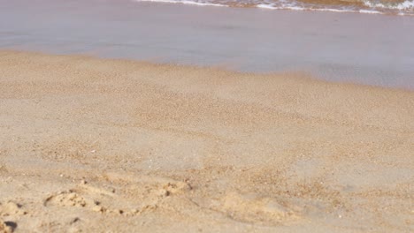 calm waves gently wash over a sandy beach in phuket, thailand, under soft natural lighting, creating a serene and tranquil atmosphere