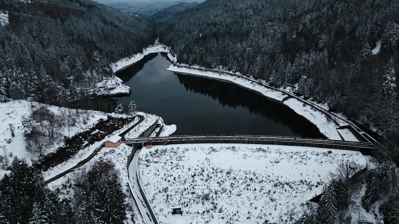 aerial shot revealing PAs du Riot dam and water reservoir during winter in le Pilat regional parc near Saint Etienne, Loire departement, Auvergne Rhone Alpes region, France