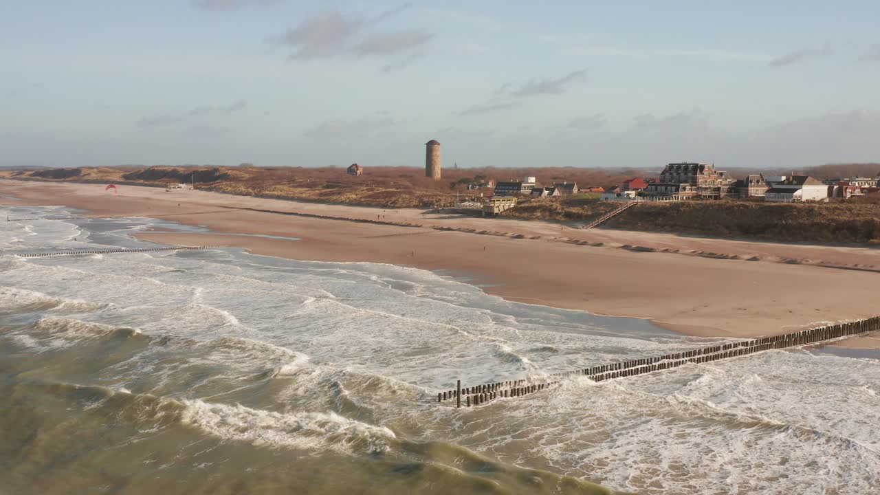 An empty beach next to the town of Domburg during a cold winter day