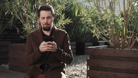 man using smartphone outdoors