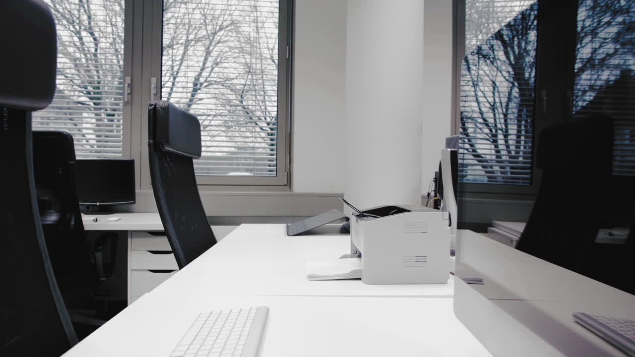 Shot of an empty desk in an office in the afternoon. Empty chairs are waiting for job applicants, office for rent or people spending their time in the homeoffice.