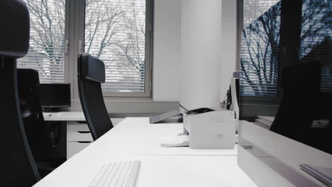 shot of an empty desk in an office in the afternoon. empty chairs are waiting for job applicants, office for rent or people spending their time in the homeoffice.