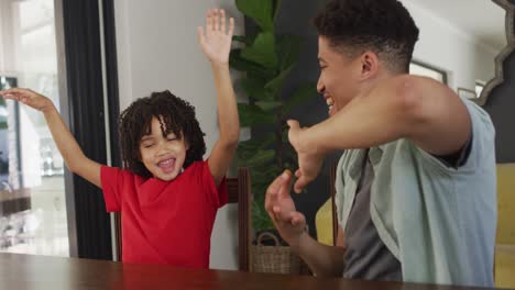 happy biracial man and his son using sign language