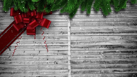 Composición-De-Video-Con-Nieve-Sobre-Cinta-De-Regalo-De-Navidad-En-Madera