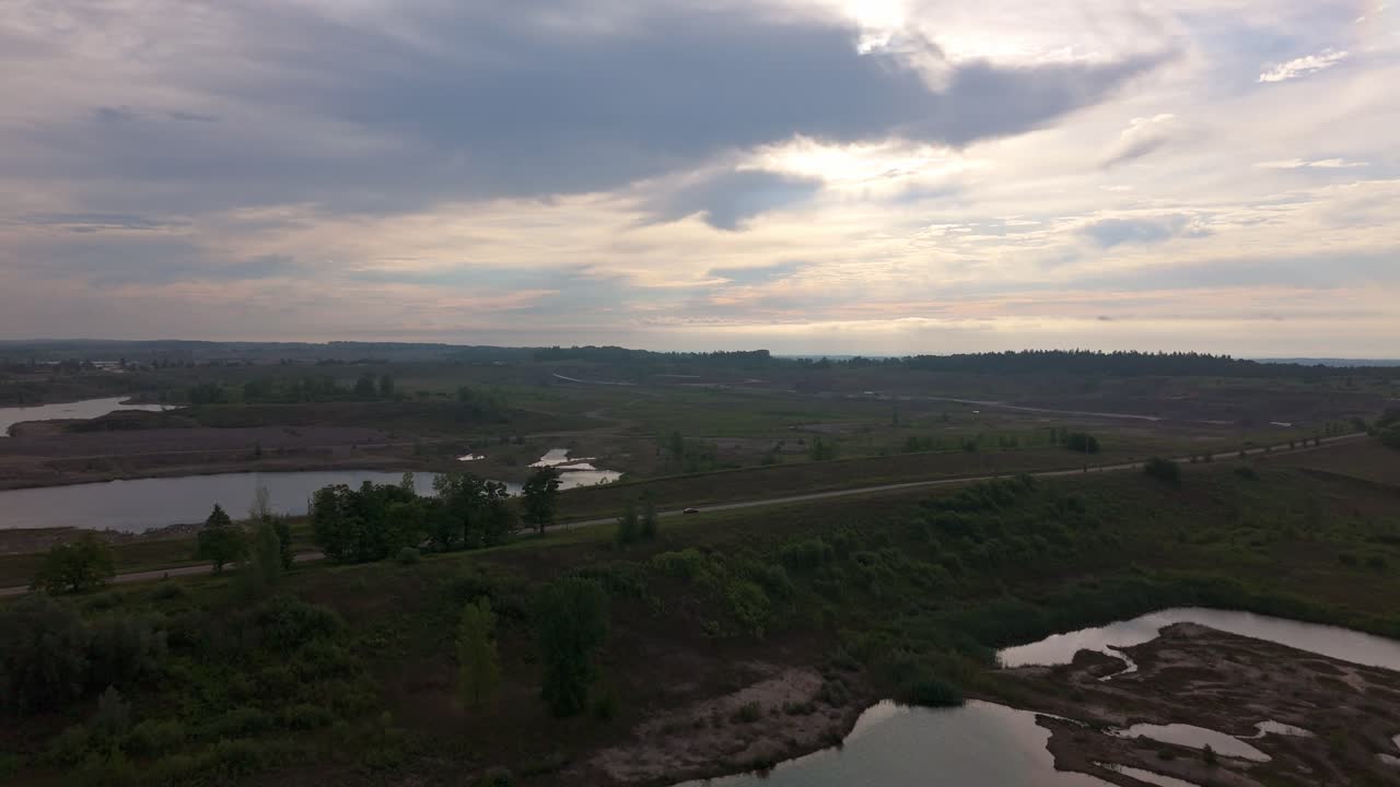 Aerial drone footage showing sand extraction sites and gravel pits during sunrise