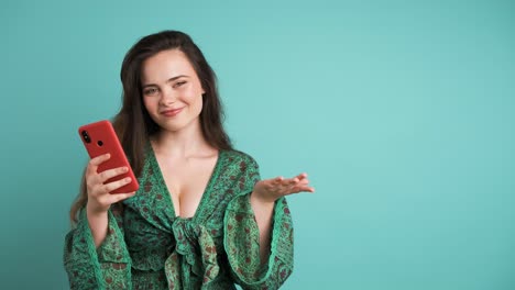 happy woman with smartphone pointing at mockup space