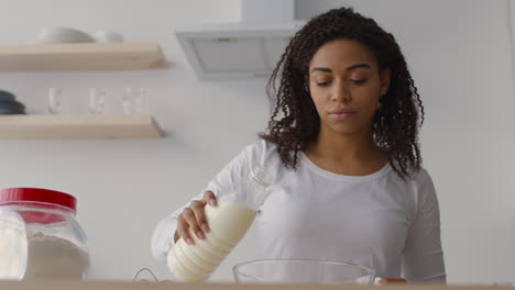 woman preparing ingredients in kitchen