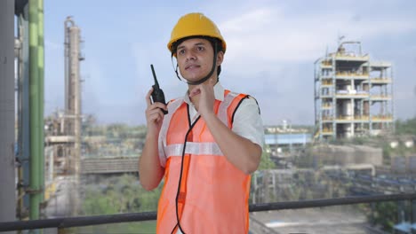 happy indian architect giving instructions on walkie talkie