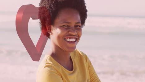 at beach, person smiling with heart shape animation overlay in background