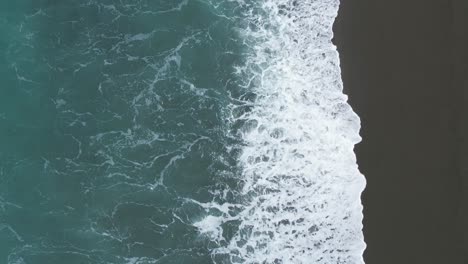 low aerial slow-motion of sparkling sunlight on breaking waves - birdlings flat beach