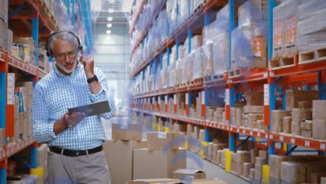 animation of digital icons over man using tablet in warehouse