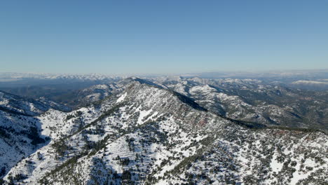 Panoramic-aerial-view-of-snowy-mountain-range-in-Sierra-de-Espadan,-Castellon,-Spain