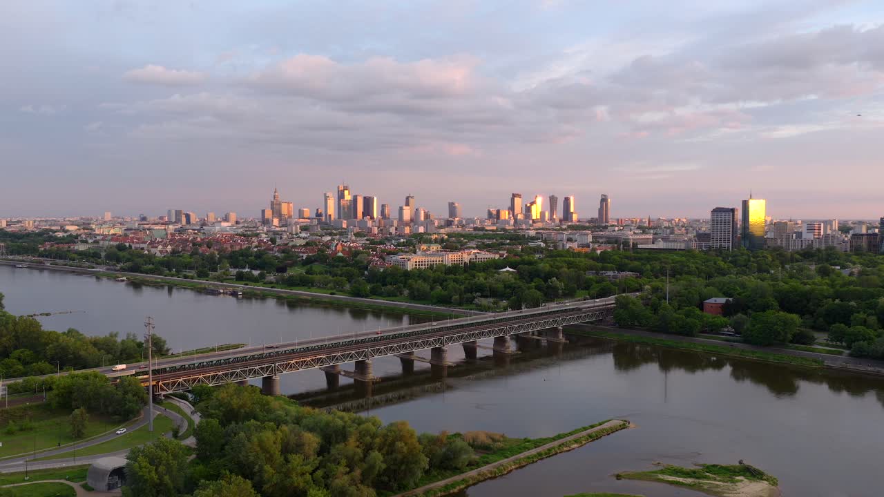 Warsaw skyline during sunset, drone shot over the vistula river and gdanski bridge, aerial view