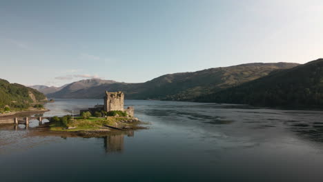 forward ascending drone shot past eilean donon castle on clear summers day