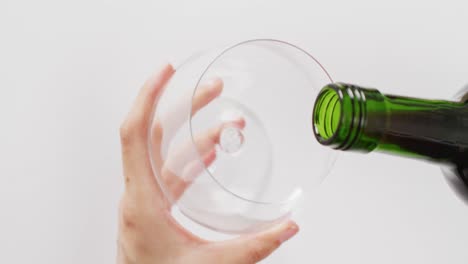 Hands-of-caucasian-woman-pouring-white-wine-into-glass-with-copy-space