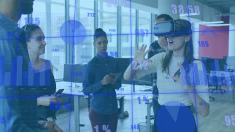 Animation of graphs, numbers, diverse woman using vr headset and giving feedback to coworkers