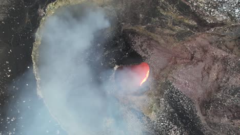 amazing spinning descending aerial shot over red lava lake of masaya, the “mouth of hell”, nicaragua