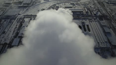 industrial area in winter with smoke and steam